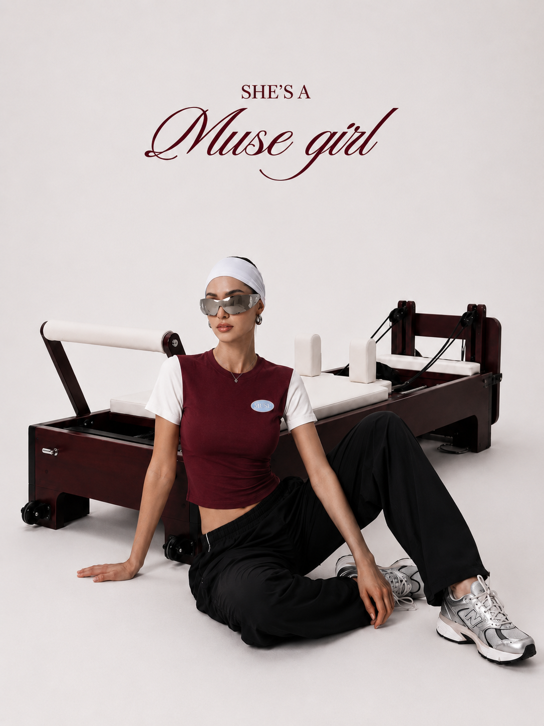 She's a Muse Girl — model in the Muse colorblock crop top and headwrap beside a reformer